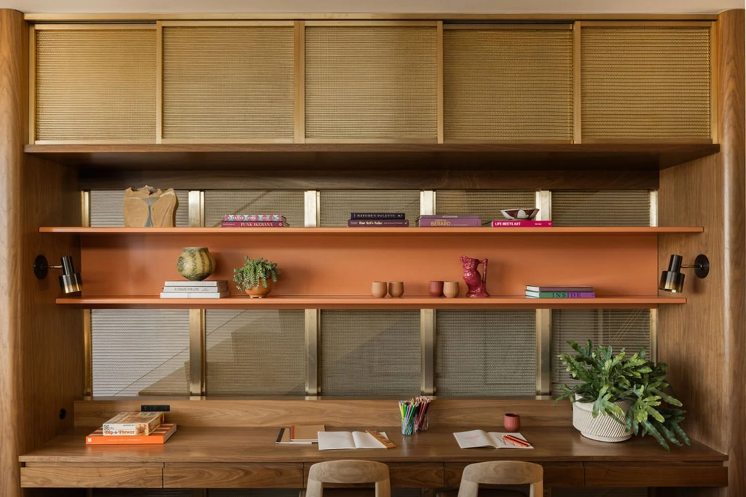 Wooden wall with shelves holding decorative items, books, and plants in a modern interior.