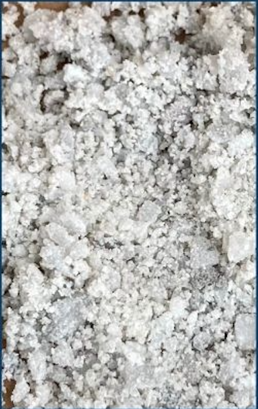 Close-up of salt or mineral crystals scattered on a surface.