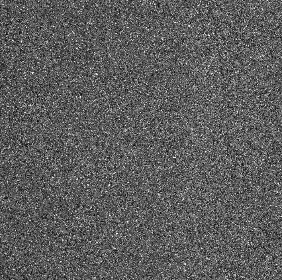 Close-up of black asphalt pavement with small gray and white specks.