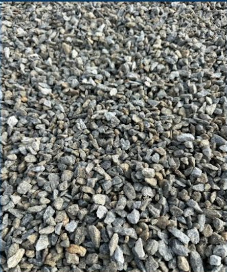 Close-up of small gray and beige gravel stones on the ground.