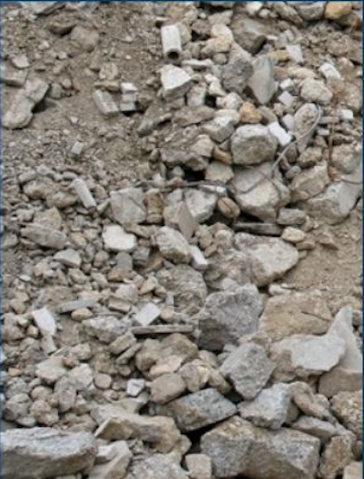 Close-up of a dirt and rocky surface with various stones and debris.