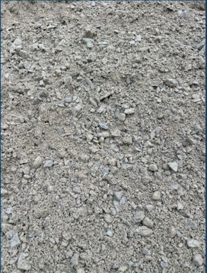 Close-up of dirt ground with small rocks and pebbles scattered across the surface.