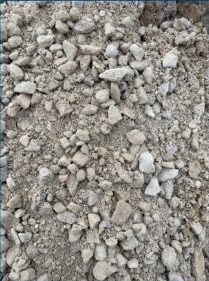 Close-up of loose gravelly dirt with small rocks and pebbles.