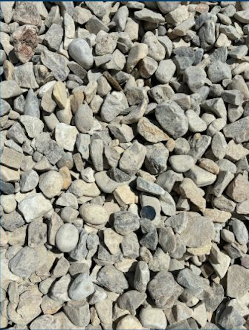 Close-up view of small, irregularly shaped rocks and pebbles on the ground.