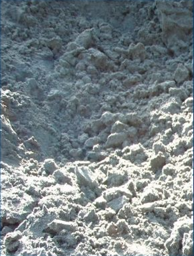 Close-up of a snowy, icy landscape with rough, uneven snow or ice formations.