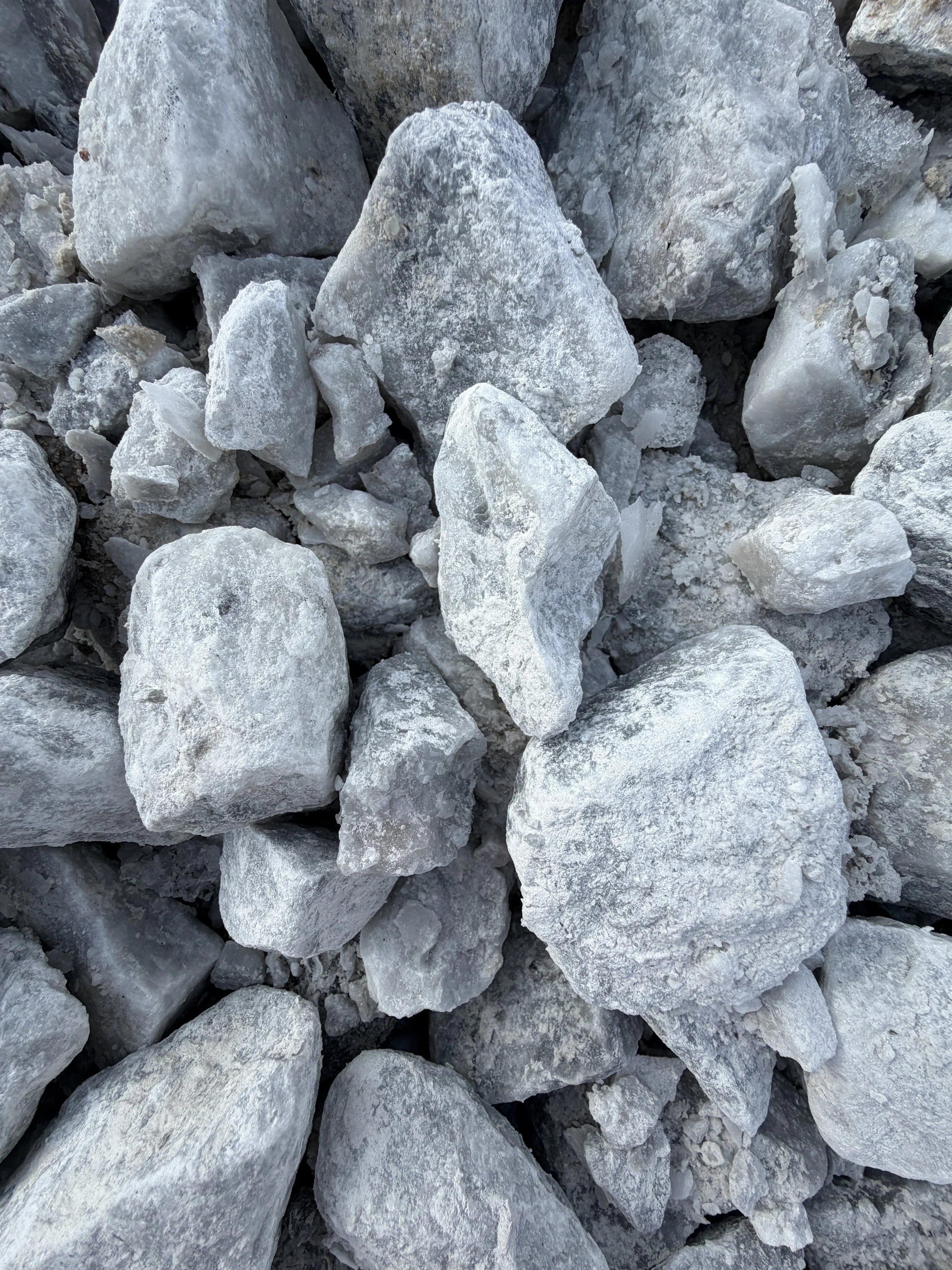 Close-up of white and light grey rocks piled together.