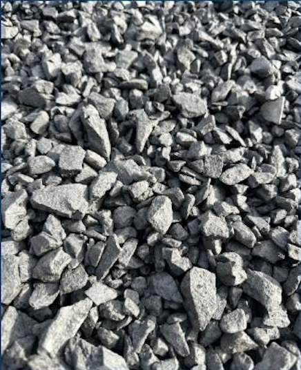 Close-up of crushed gray rocks or gravel on the ground.