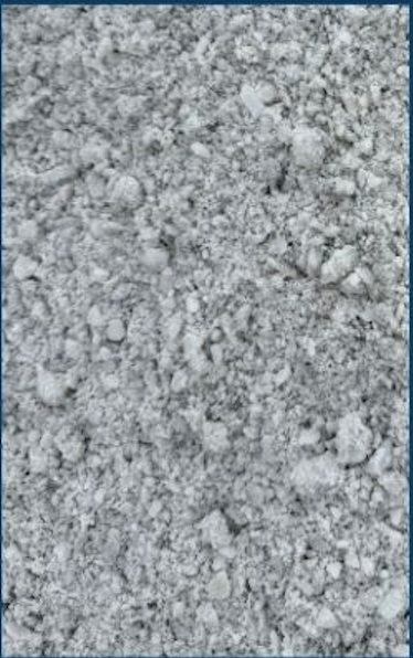 Close-up of gray crushed gravel or small stones on a surface.