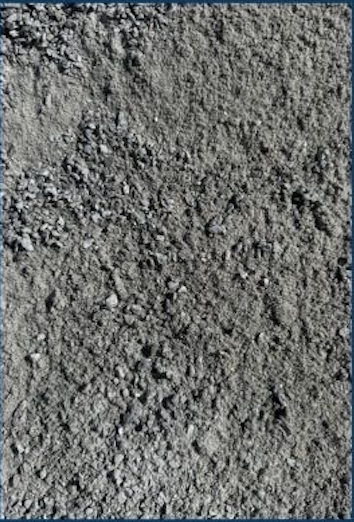 Close-up of gray dirt or gravel surface.