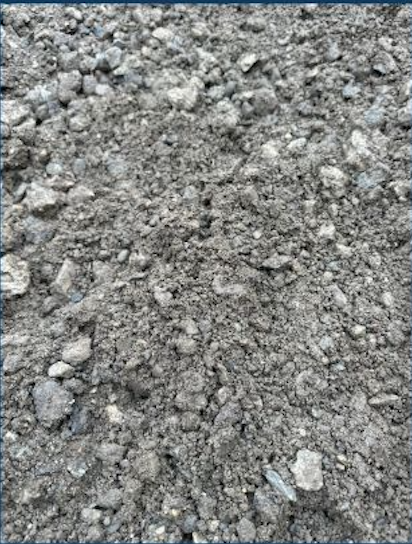 Close-up of dry, uneven dirt or soil ground with small rocks and pebbles.
