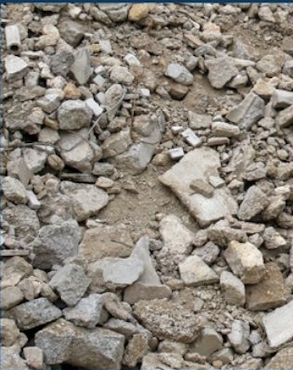 A close-up of a dirt ground covered with various sizes and shapes of rocks and gravel.