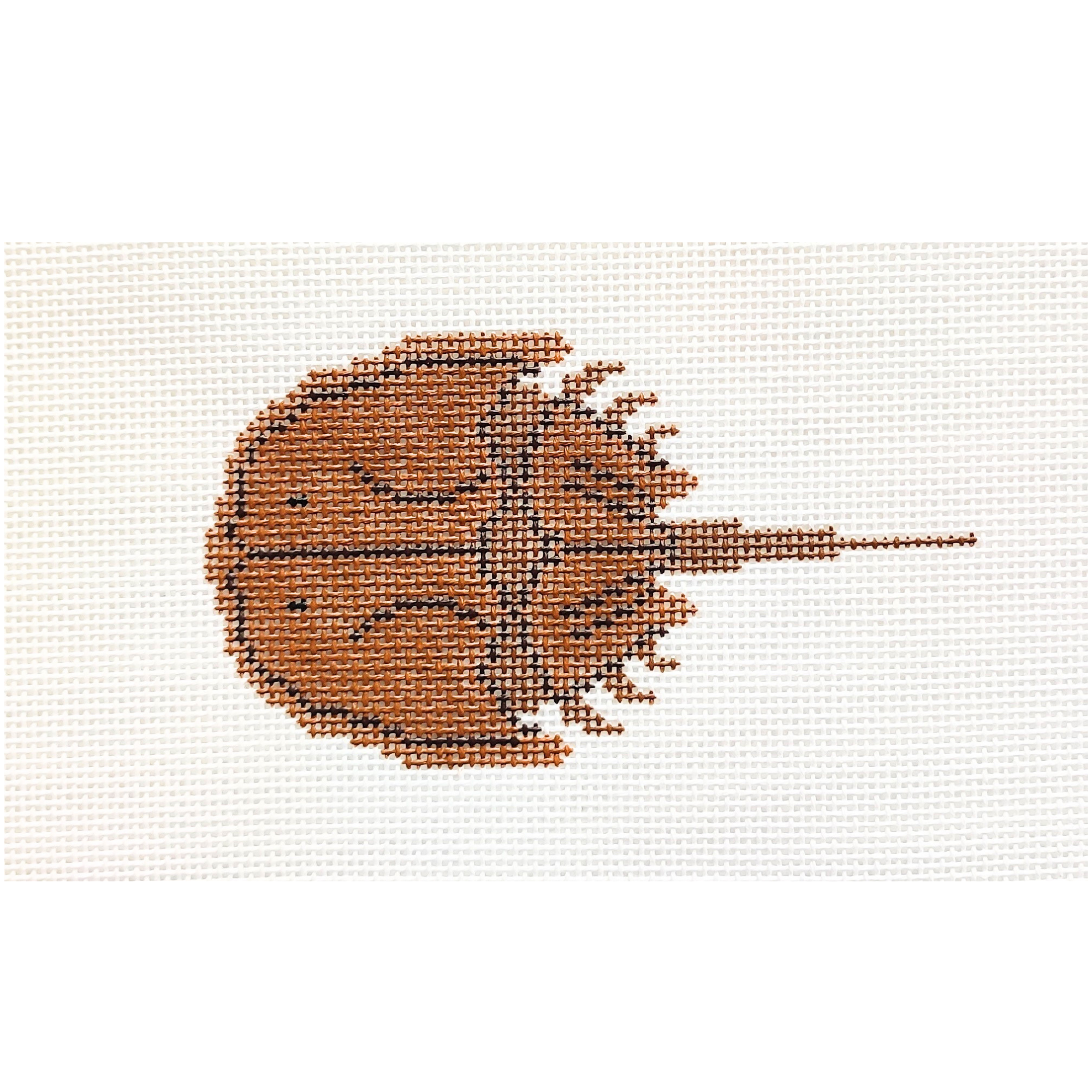 Needlepoint design of a horseshoe crab in brown on a white background.