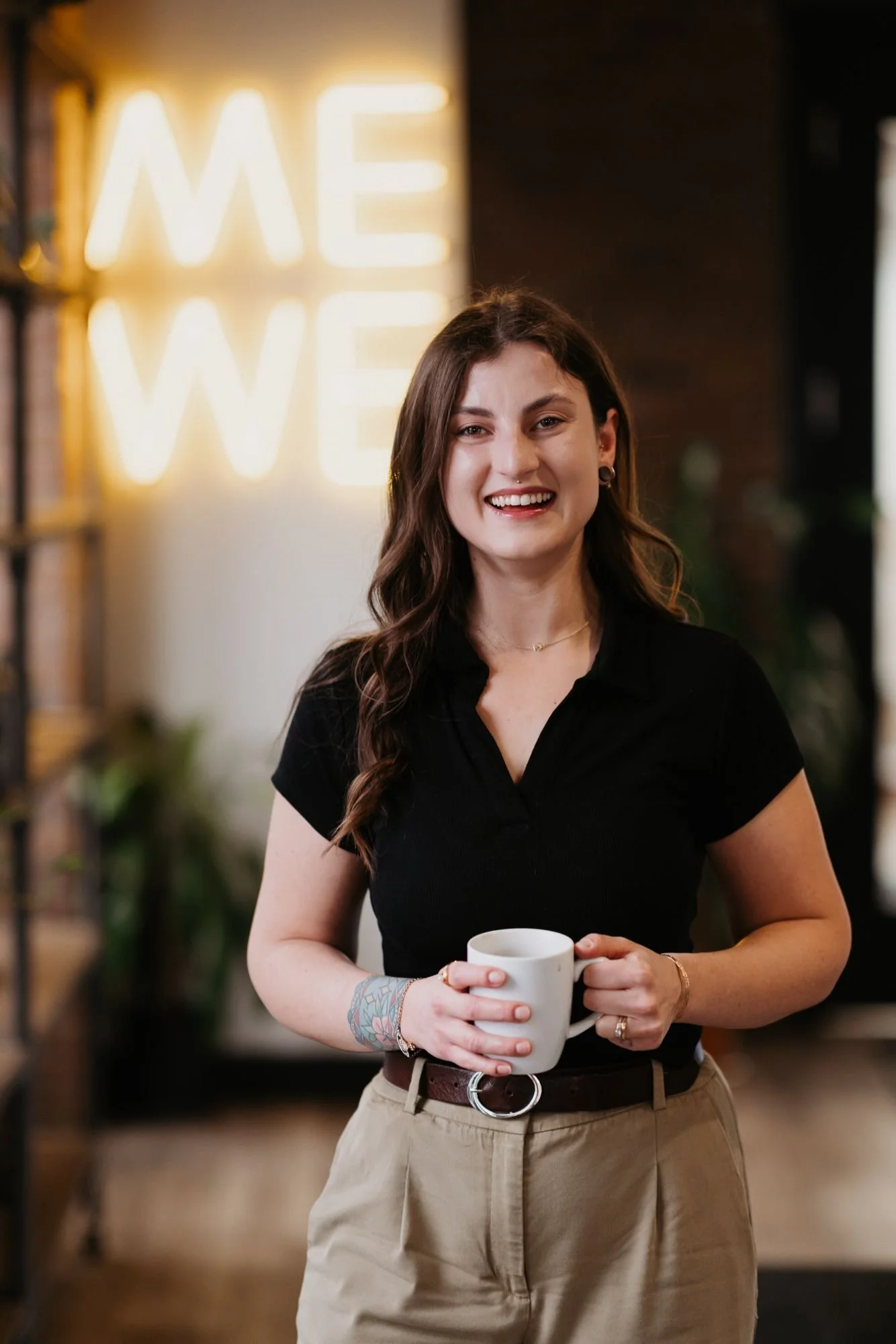 Samantha Stone, therapist in Kelowna, smiling with cup of coffee.