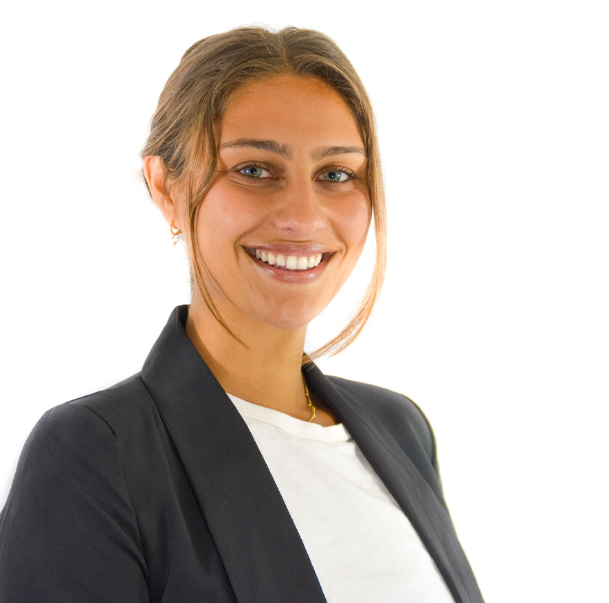 A smiling woman with light brown hair, wearing a black blazer and a white shirt, against a white background.