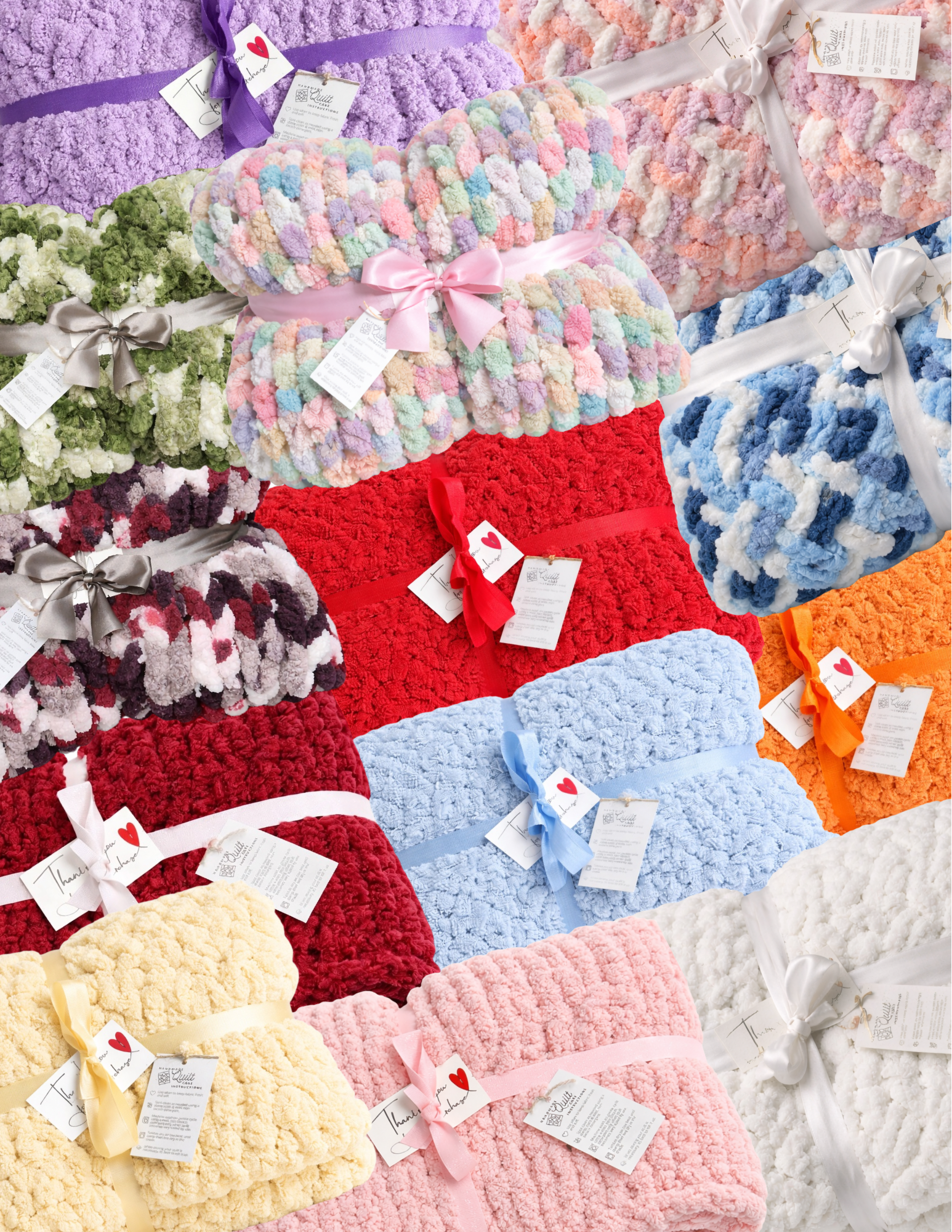 A display of colorful, fluffy, plush blankets in various pastel shades, each tied with satin ribbons and tags.