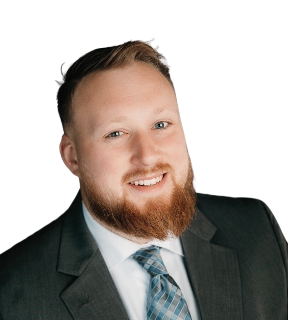 A smiling man with a beard in a suit and tie posing for a professional headshot.