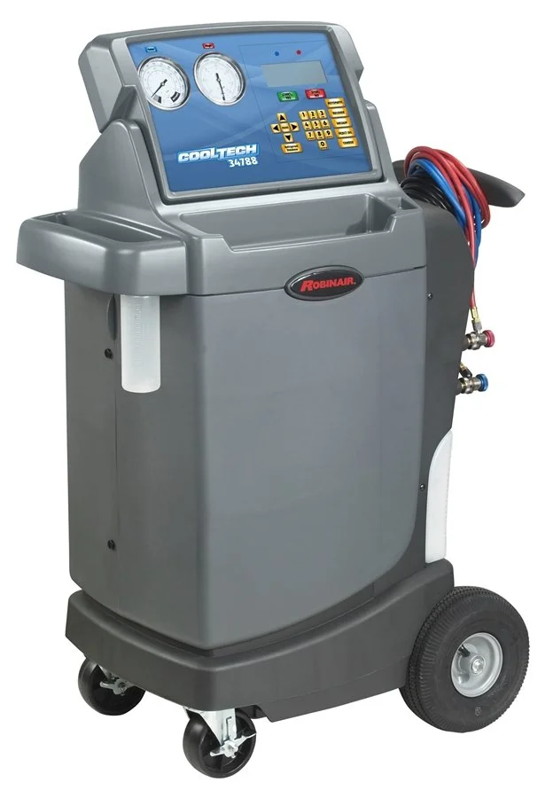 Automotive air conditioning service machine with gauges, control panel, and hoses.