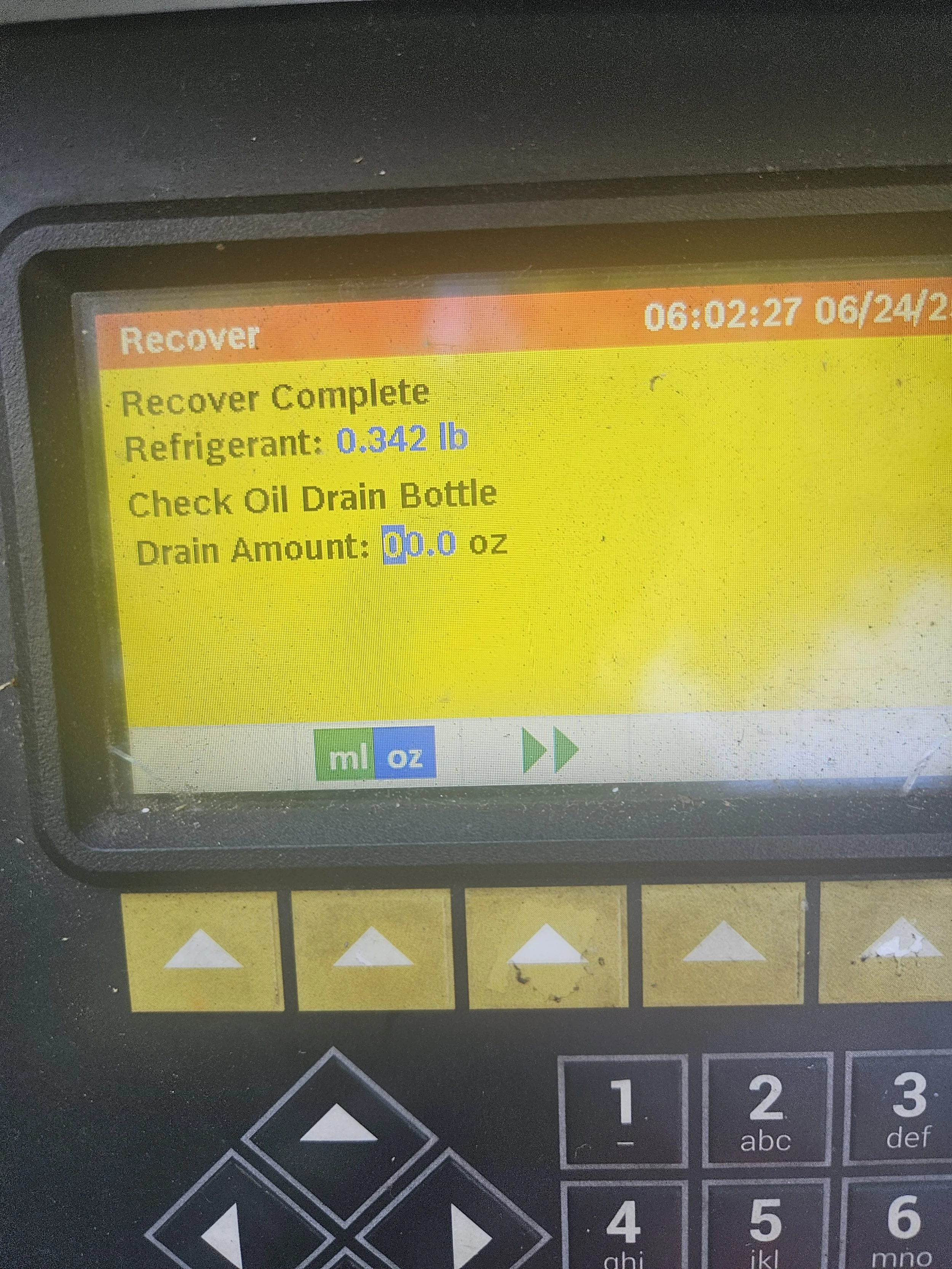 Control panel screen showing that the recovery process is complete with refrigerant amount of 0.342 lb and oil drain bottle empty at 6:02 AM on June 24, 2023.