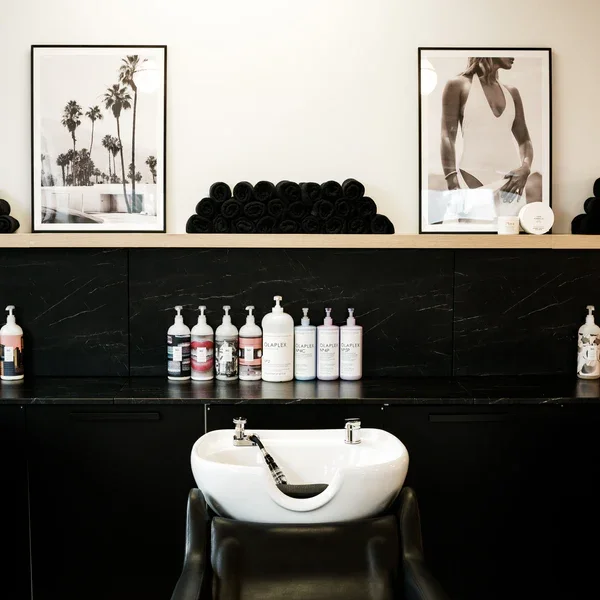 Luxury salon shampoo area and product display at Private Studio in Toronto