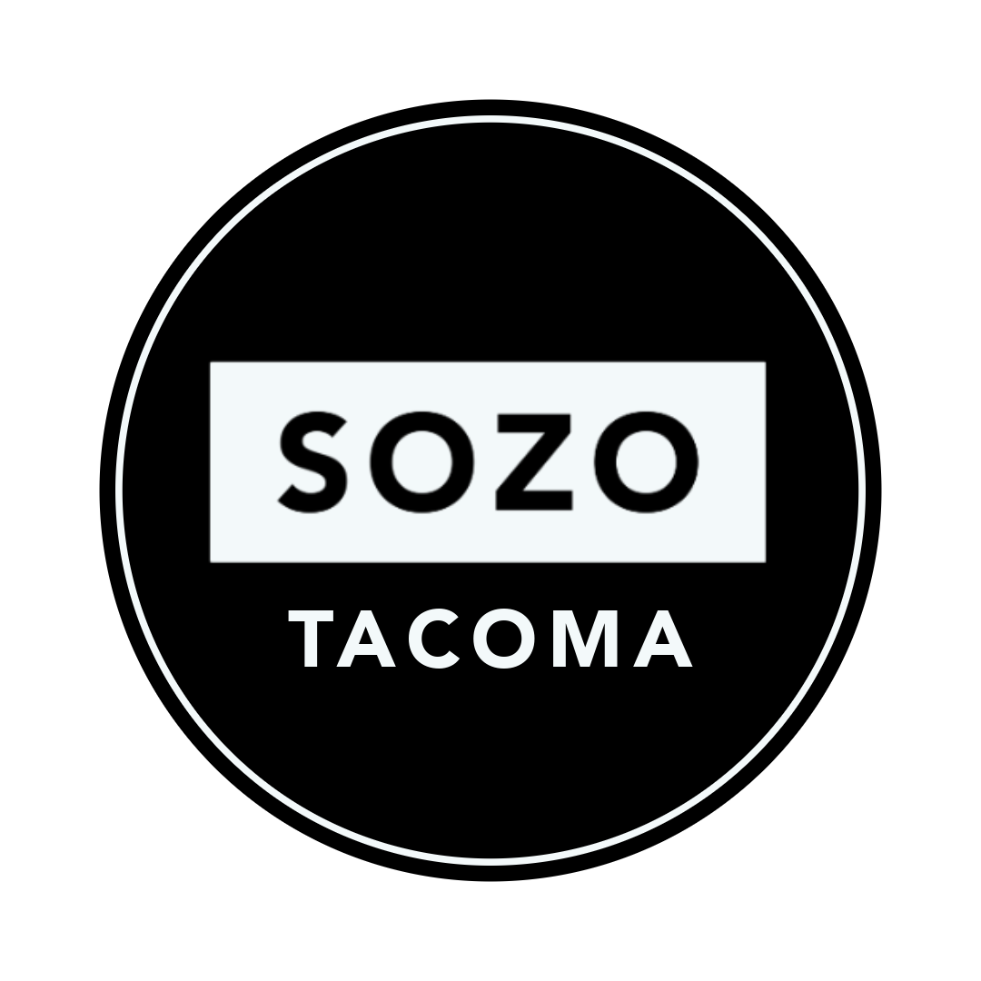 Black circle logo with the word 'SOZO' in bold black letters inside a gray rectangle, and 'TACOMA' underneath in white text.