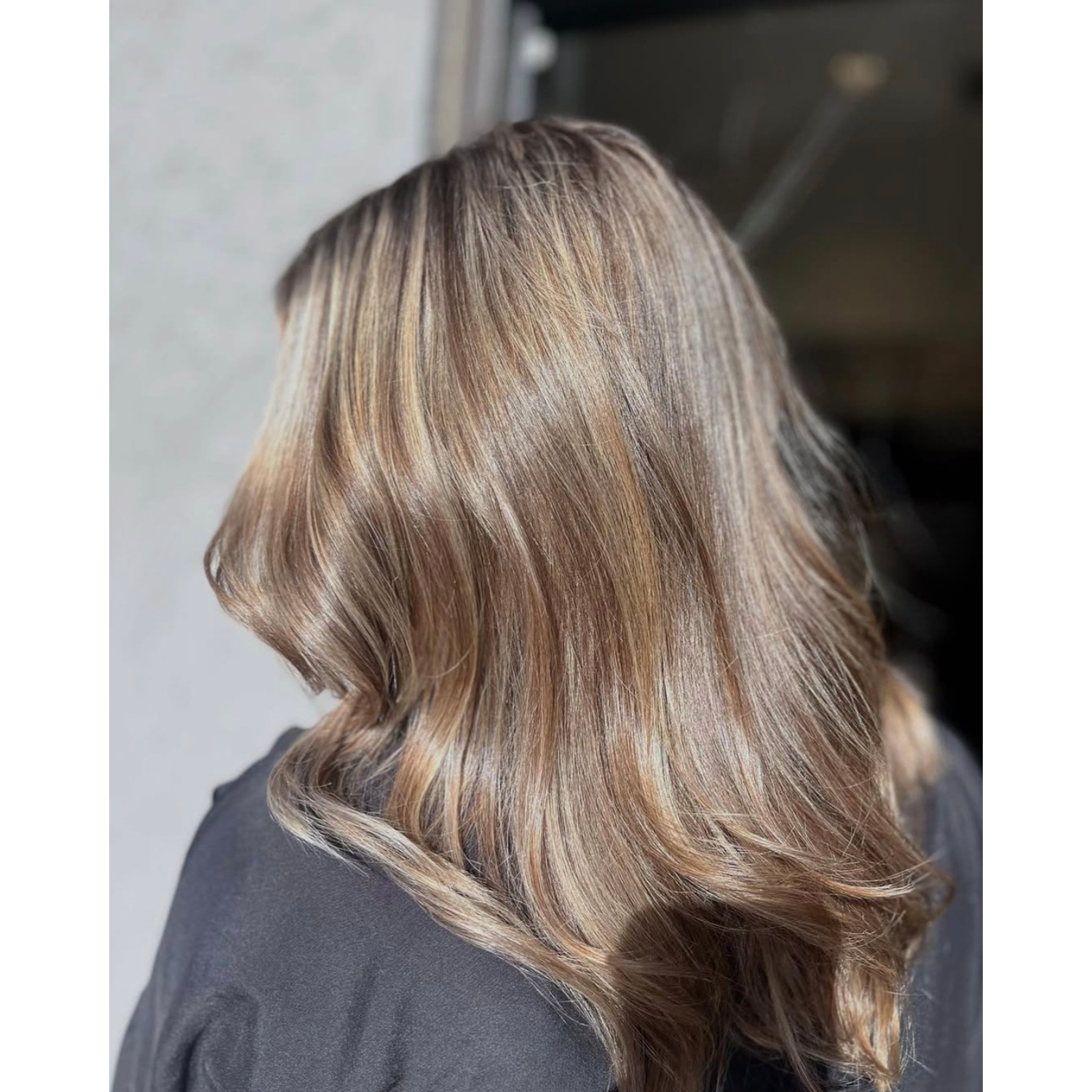 Wavy, shoulder-length hair with highlights and lowlights in shades of blonde and light brown.