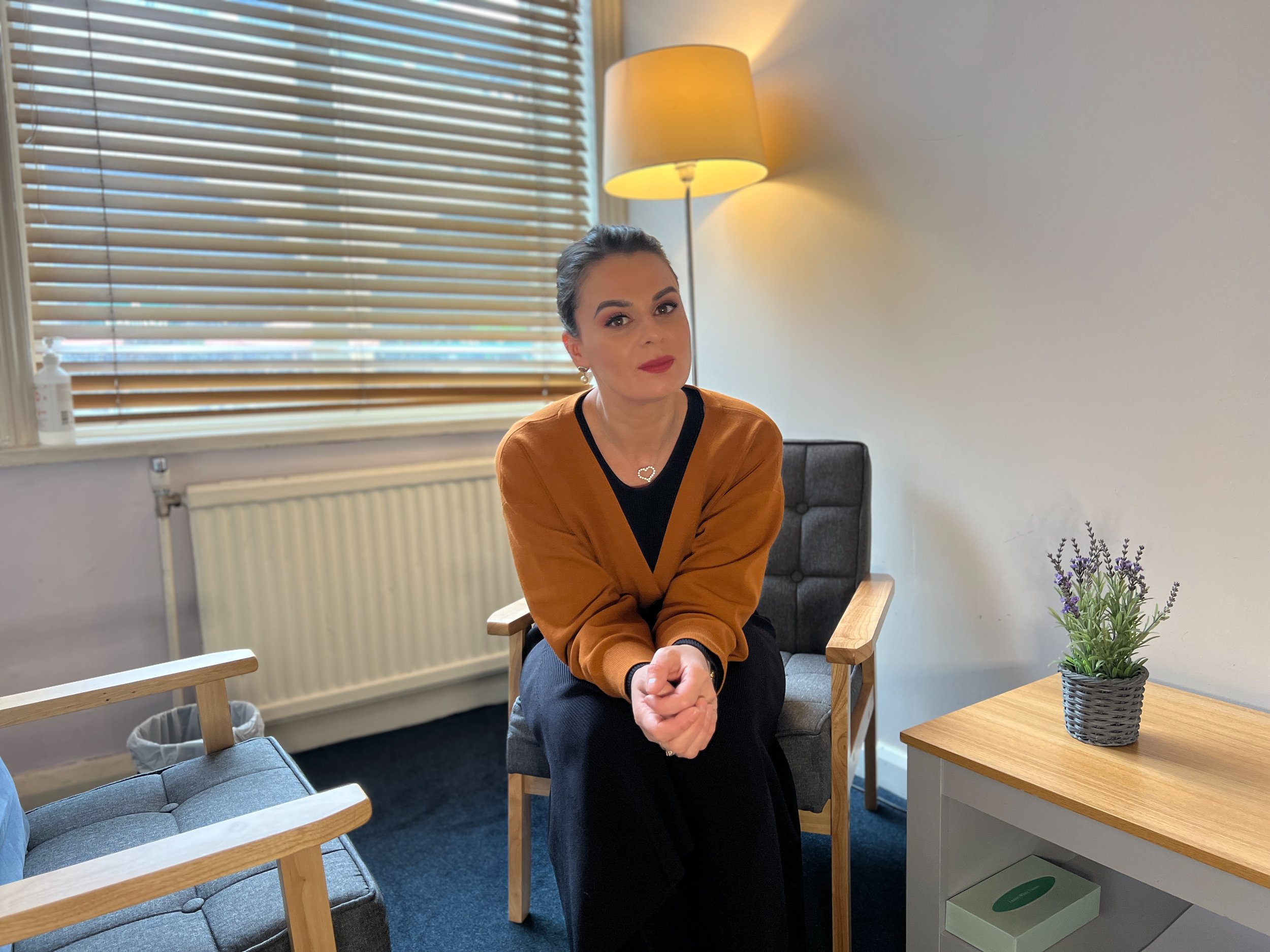 Mariana Aleksieva wearing a caramel-colored sweater sitting in her office on London Bridge