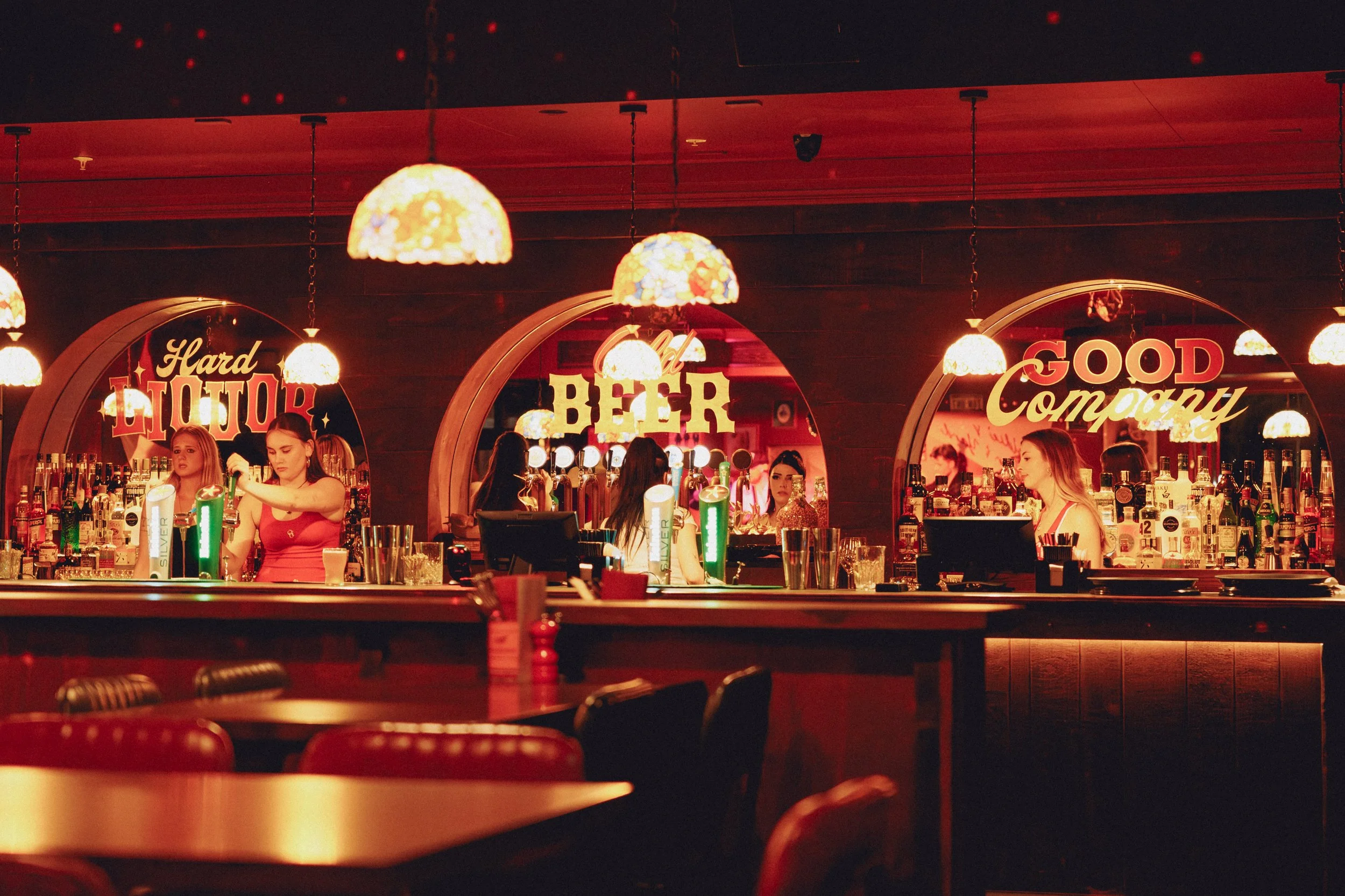 Interior of Goldies Bar, Takapuna, featuring custom arched joinery, bar counter and warm ambient lighting by Form & Finish.