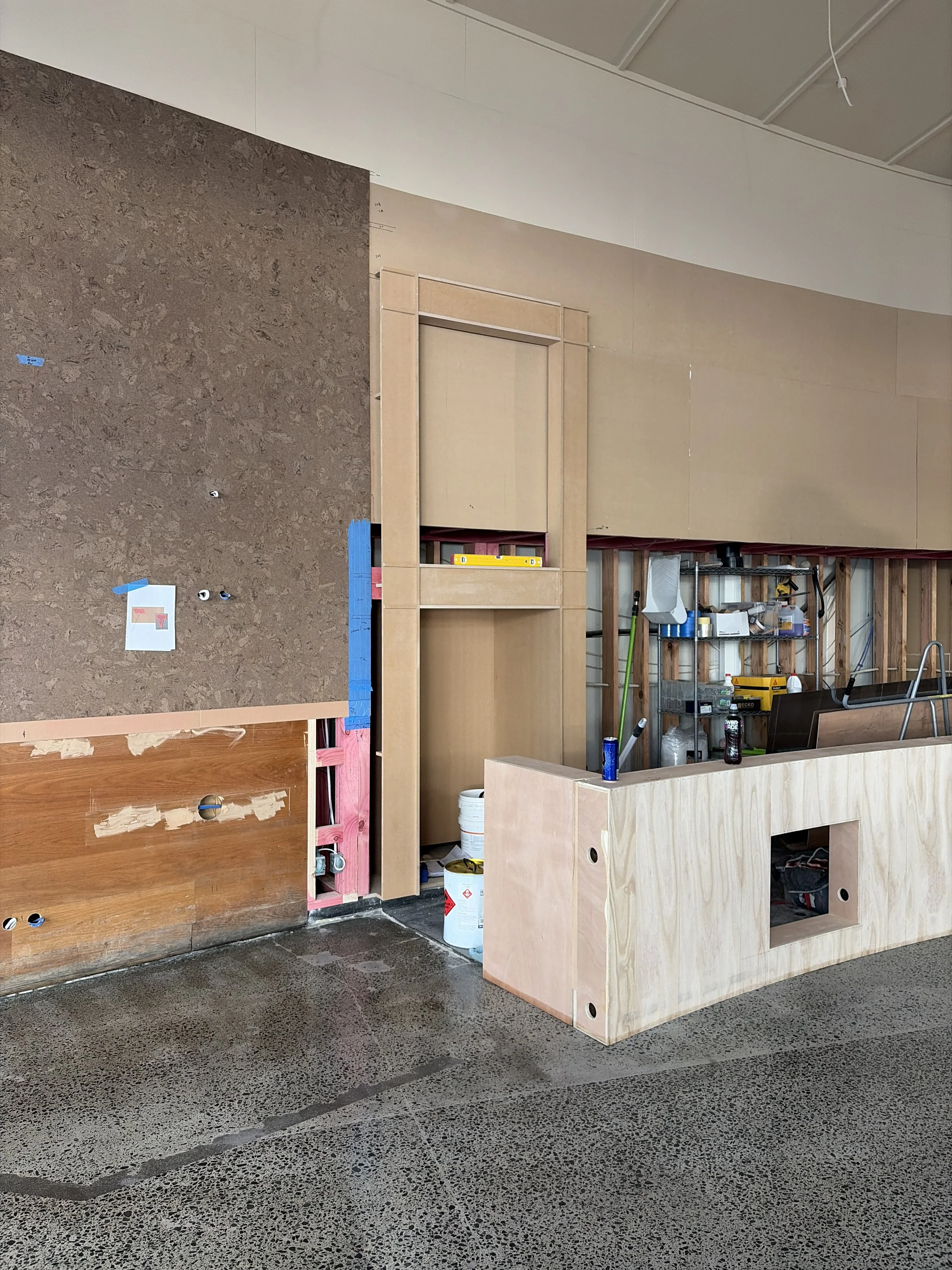 Custom cabinetry and cork wall tiling being fitted at Sports & Rec Bar.