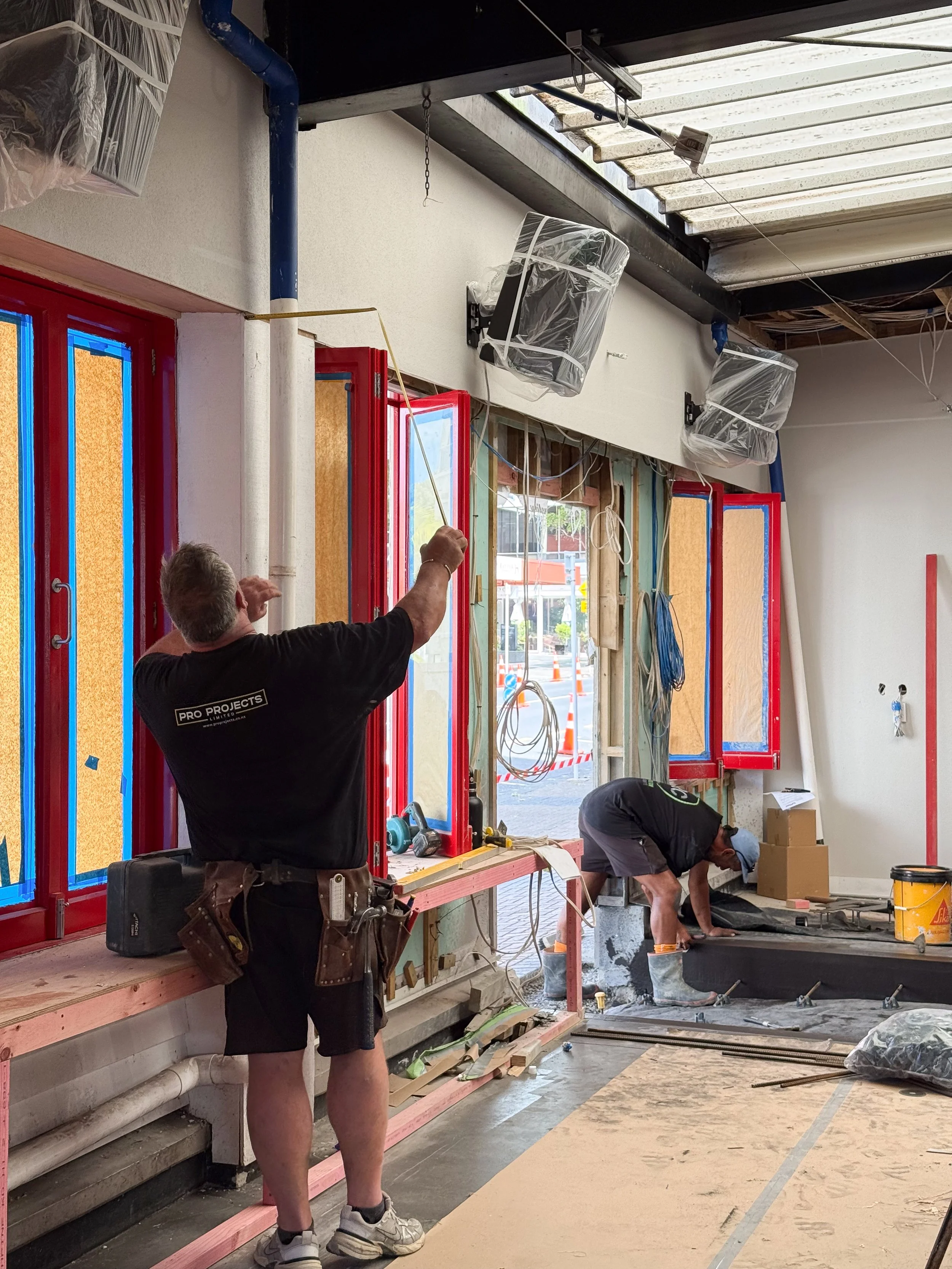 Entrance joinery and cork wall panelling being installed during the fit-out of Goldies Bar, Takapuna.