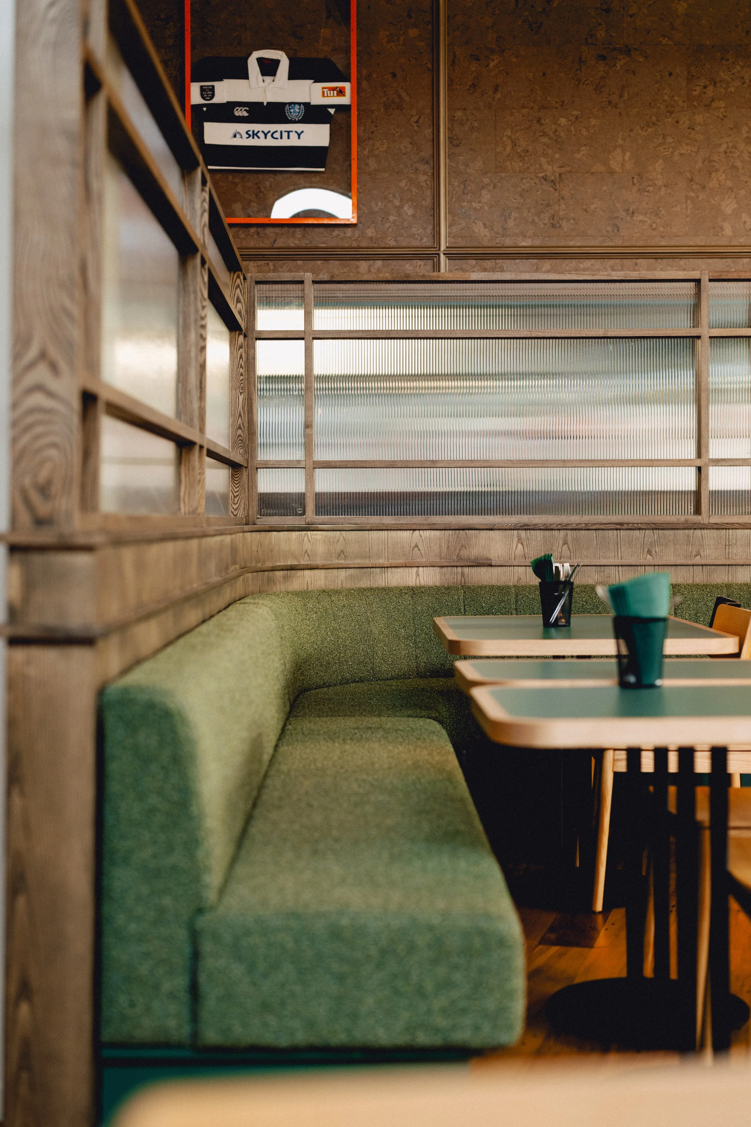 Detail shot of custom booth seating, timber joinery and cork wall tiling at Sports & Rec Bar.