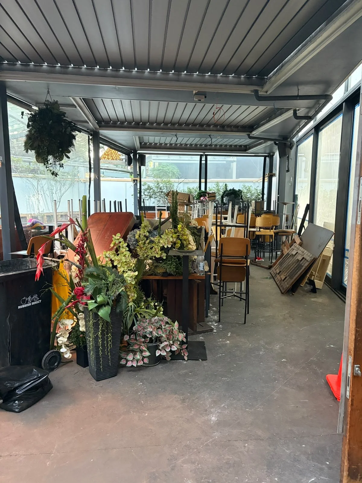 Outdoor area of Sports & Rec Bar mid fit-out, with furniture and fixtures ahead of installation.