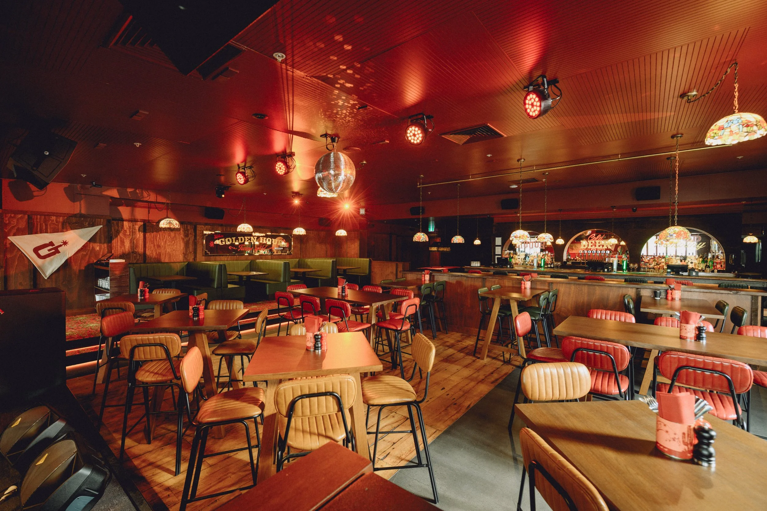 Wide interior shot of Goldies Bar, Takapuna, showcasing the full fit-out including timber ceiling panelling, custom joinery and bar by Form & Finish.