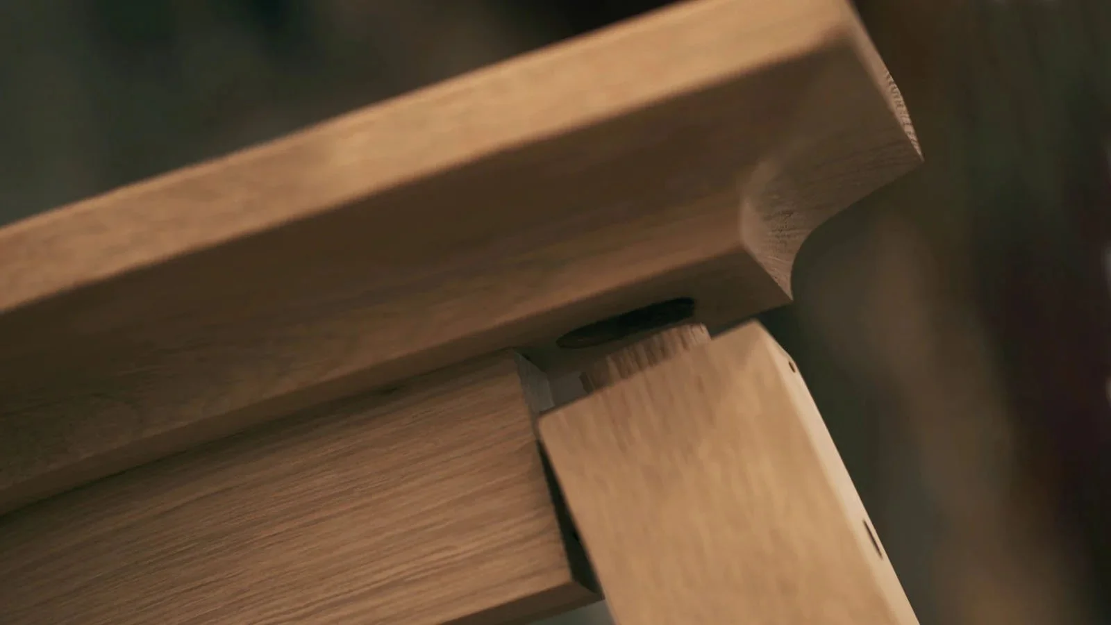 Close-up of interlocking wooden pieces with smooth finishes and rounded edges.