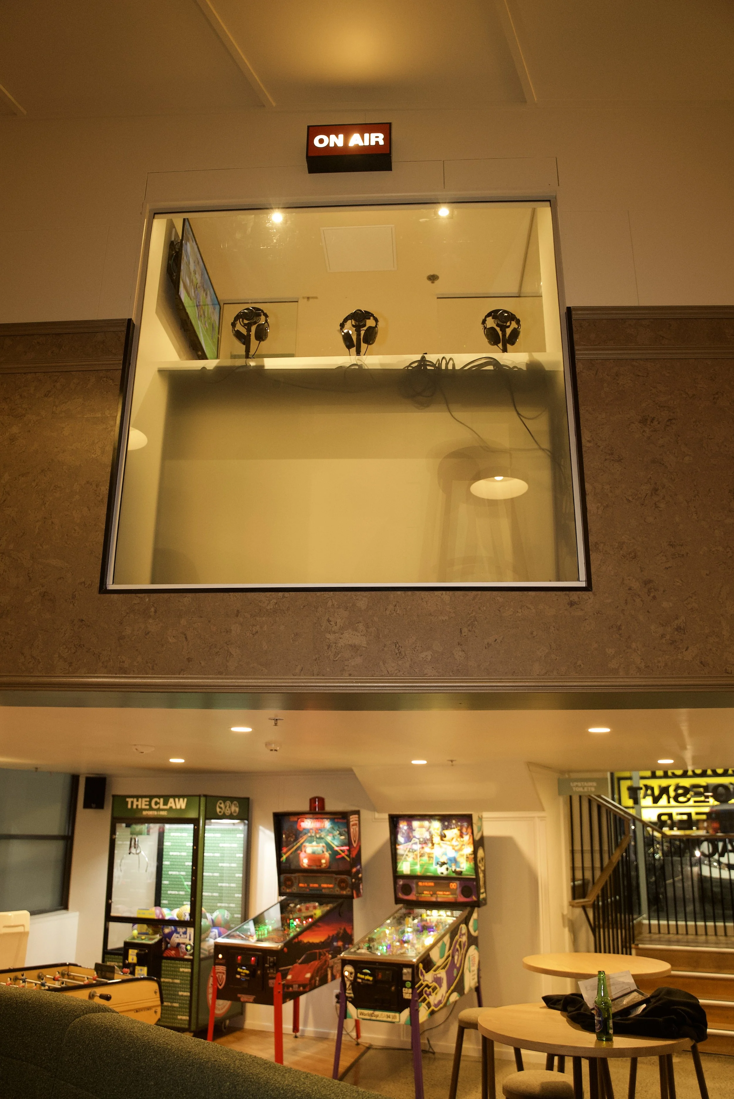 Completed podcast booth and games area at Sports & Rec Bar, featuring cork wall tiling and custom joinery.