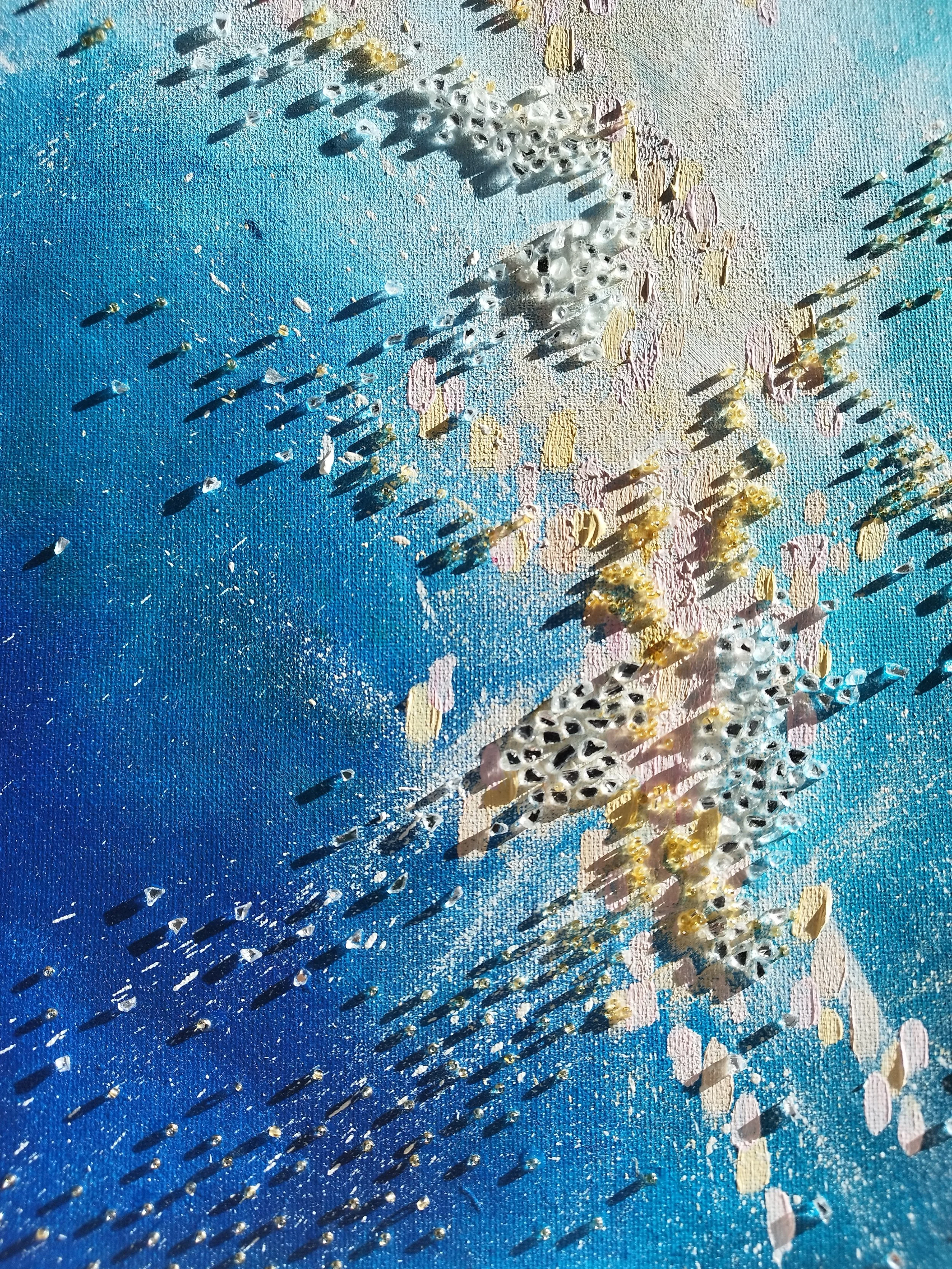 Close-up of textured abstract painting with pastel background, scattered metallic and pearlescent embellishments, and shadows cast by the glittering objects.