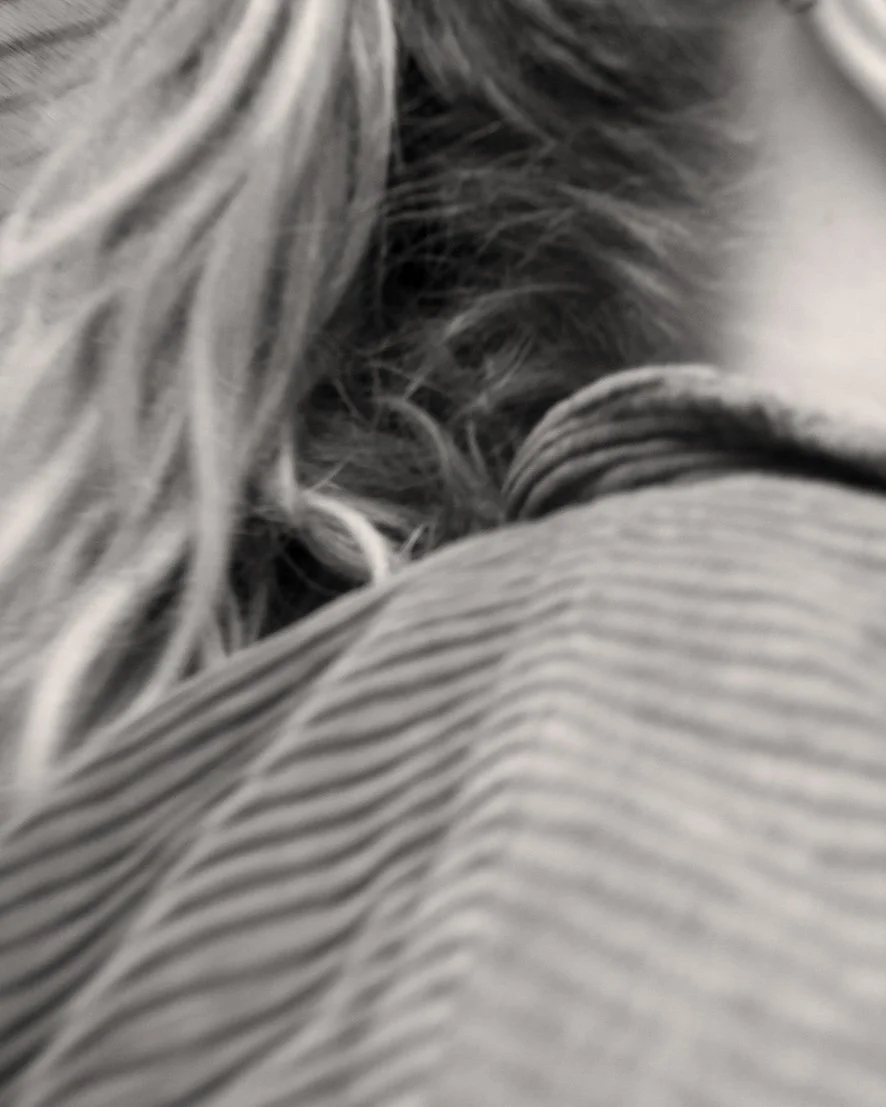 Close-up of a person's hair with a blurred background, showing wavy and straight strands.