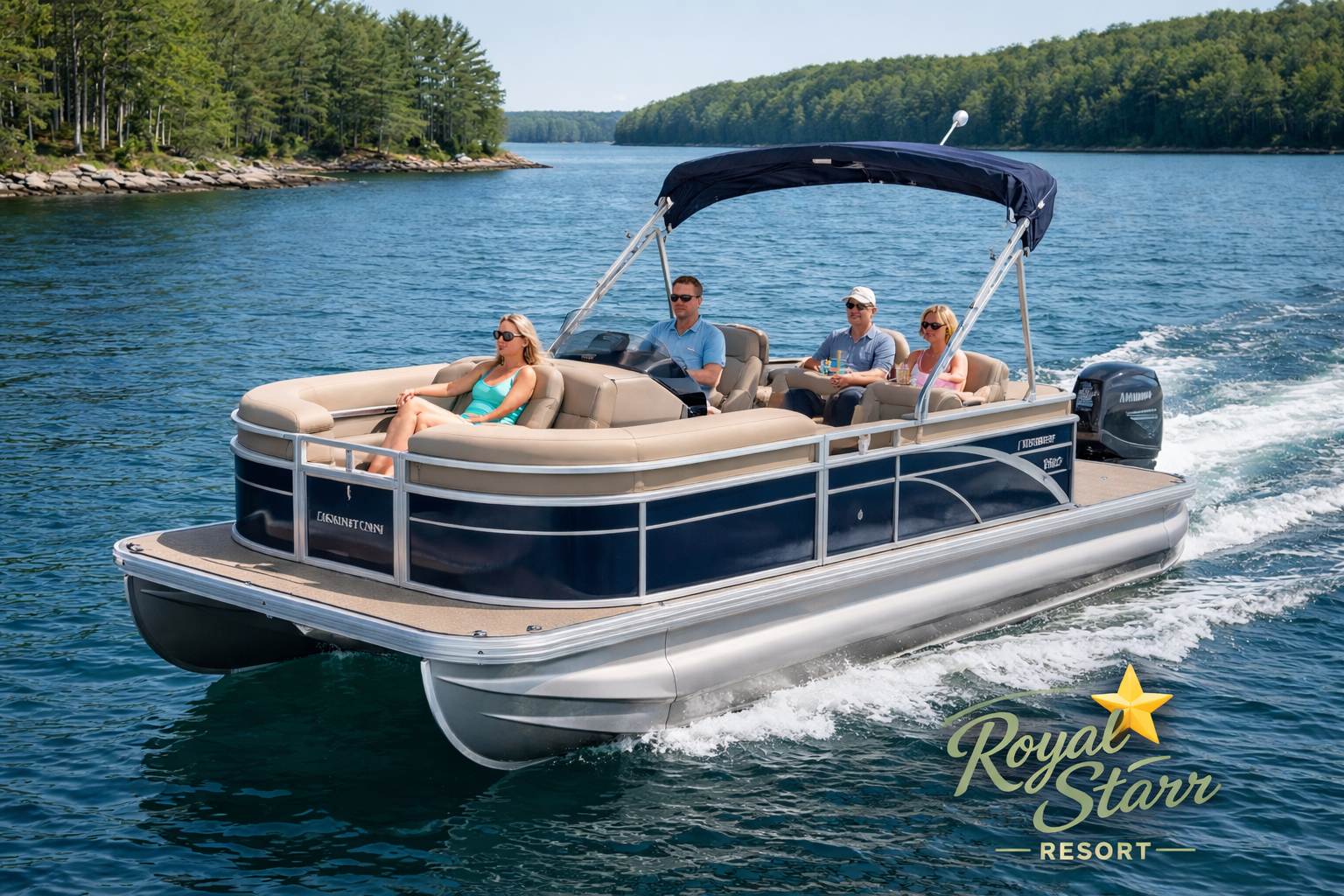 A pontoon boat with four people on board, cruising on a lake surrounded by forested shoreline.