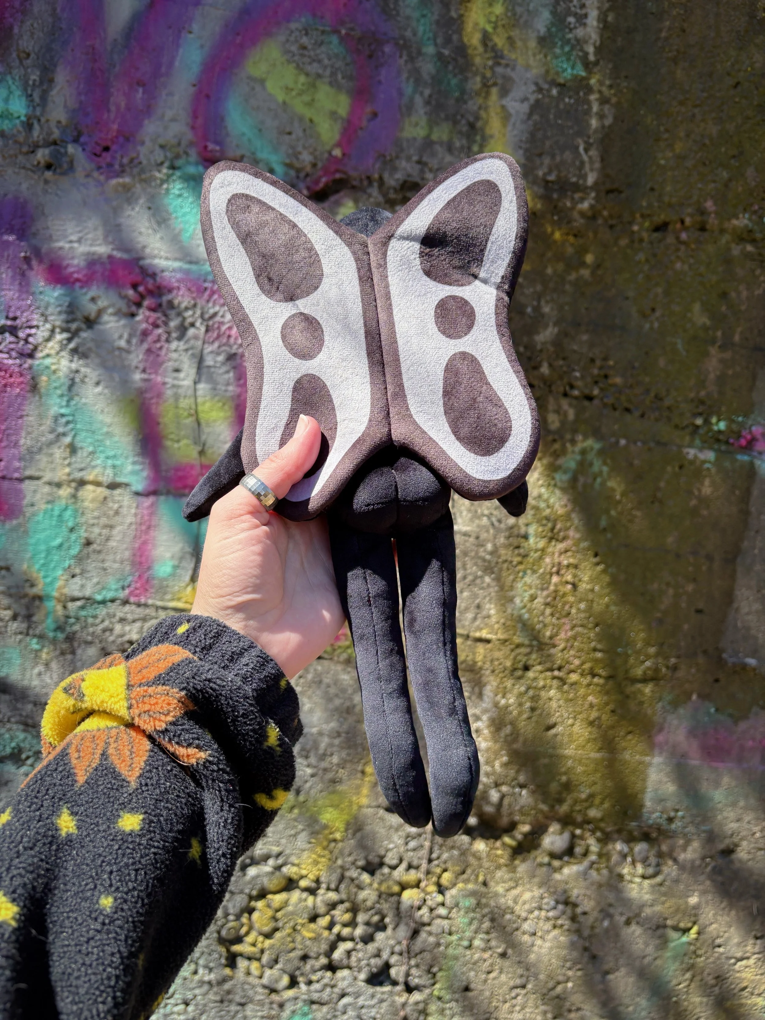 mothman plush graffiti behind.JPG