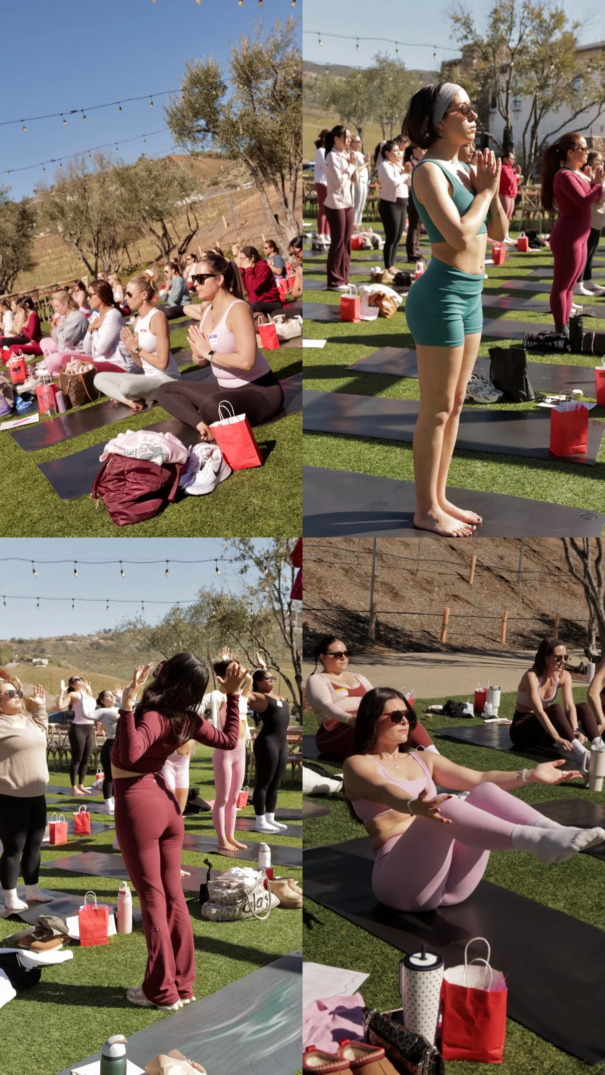 A group of women participating in an outdoor yoga or meditation class on a grassy area with string lights overhead. Some women are sitting cross-legged with hands in prayer position, others are standing or stretching on yoga mats. The scene is sunny with clear skies and trees in the background.
