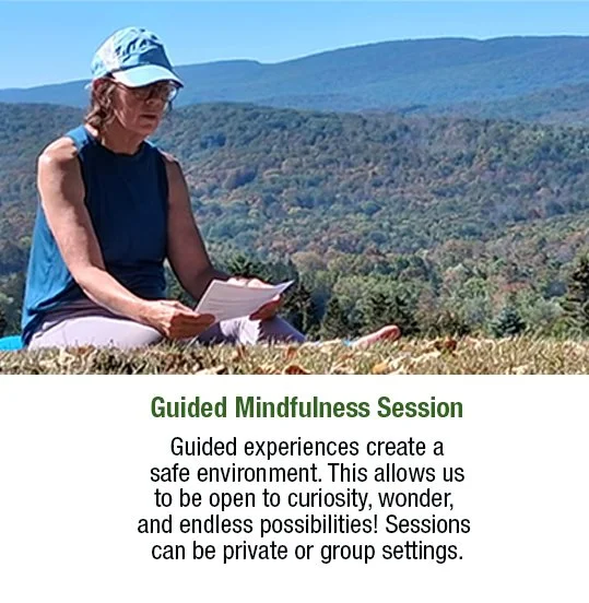 A woman sitting outdoors on grass, reading a paper, with mountains and trees in the background, promoting a guided mindfulness session.
