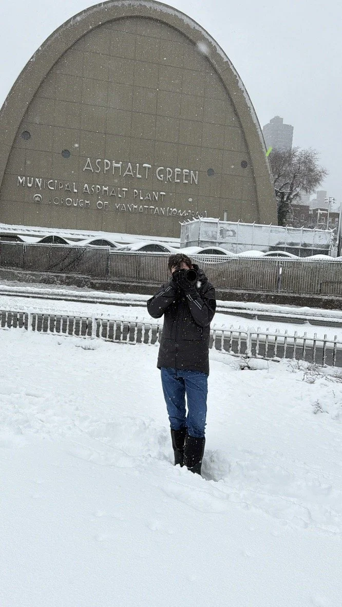 Joseph Englander photographing in the snow outside Asphalt Green in Manhattan