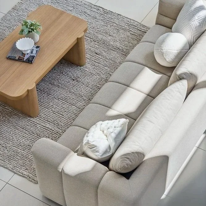 Contemporary living room interior with neutral furnishings and timber finishes by Hansen Living on the Gold Coast.