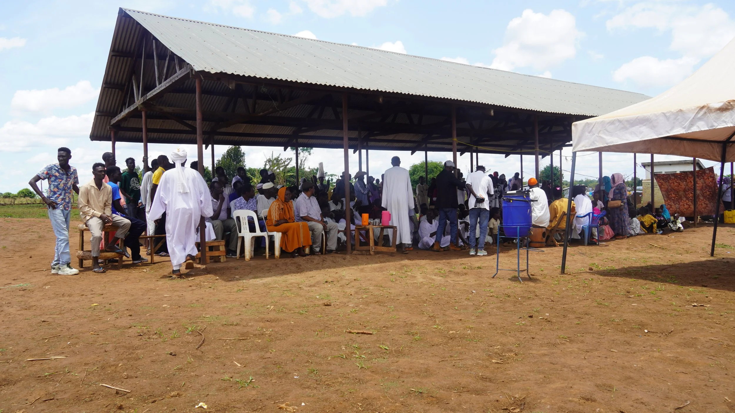Cluster A Eid crowd under the big shelter.JPG