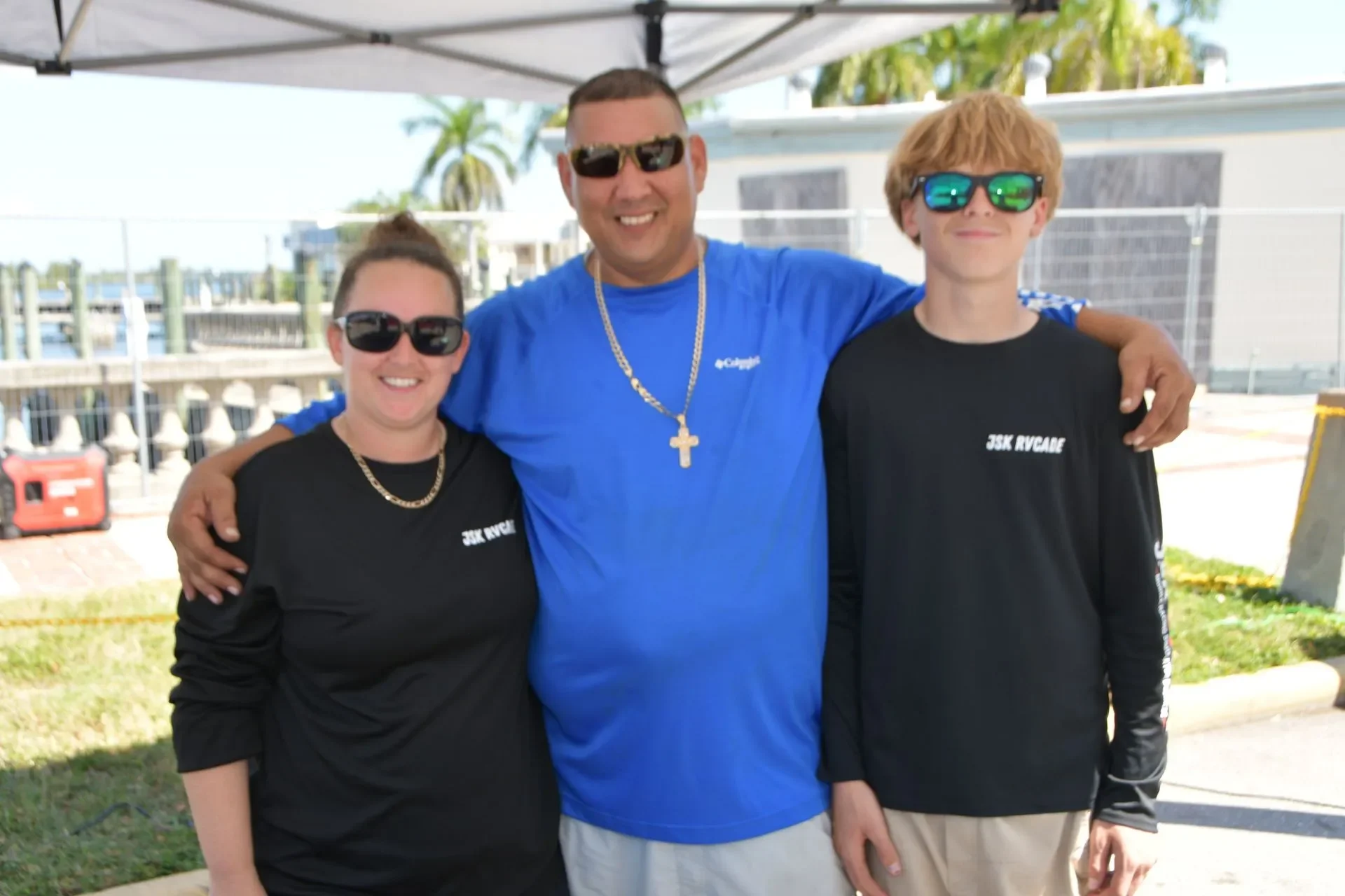 JSK RVCADE family standing together at an outdoor waterfront event