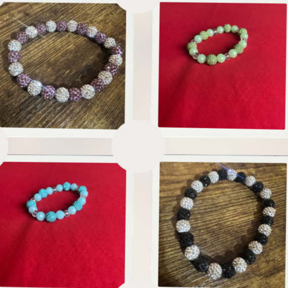 Four beaded bracelets, each with different color beads, displayed on various backgrounds: purple beads on wood, green beads on red, blue beads on red, black and white beads on wood.