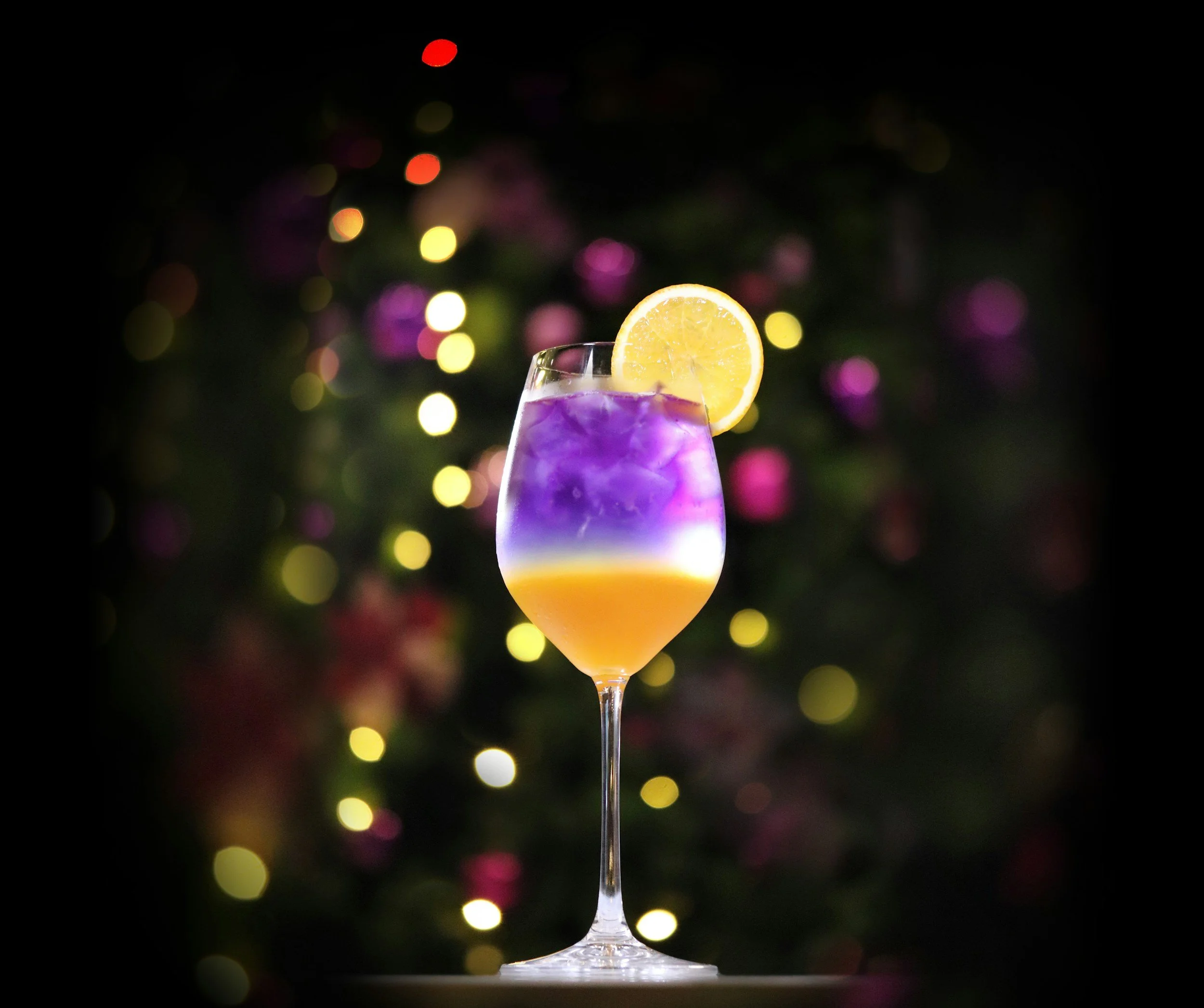 Purple and yellow drink with ice