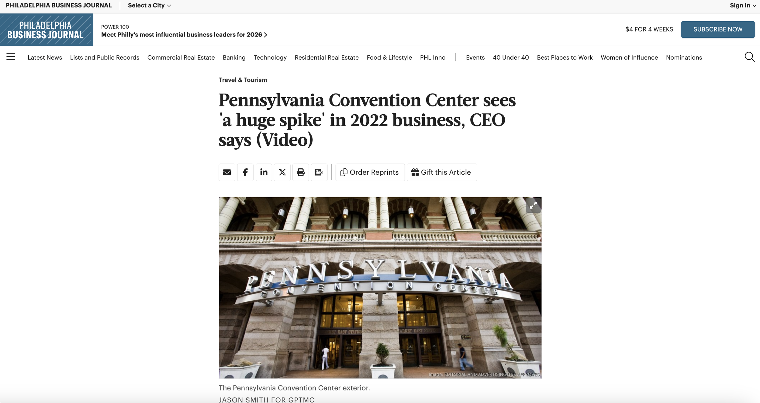 Exterior of the Pennsylvania Convention Center with a sign reading 'Pennsylvania Convention Center' above the entrance, showing large columns and glass doors.