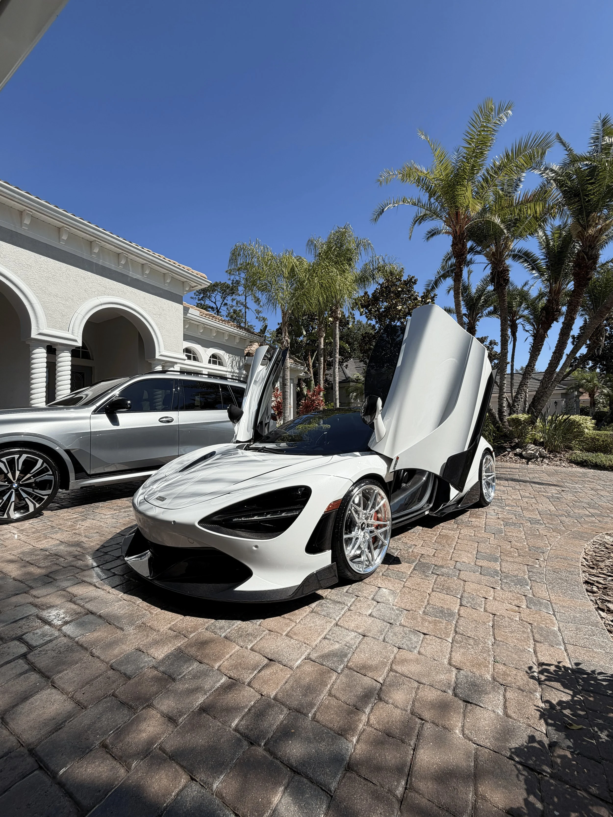 McLaren 720S dihedral doors open after professional mobile detailing in Tampa FL