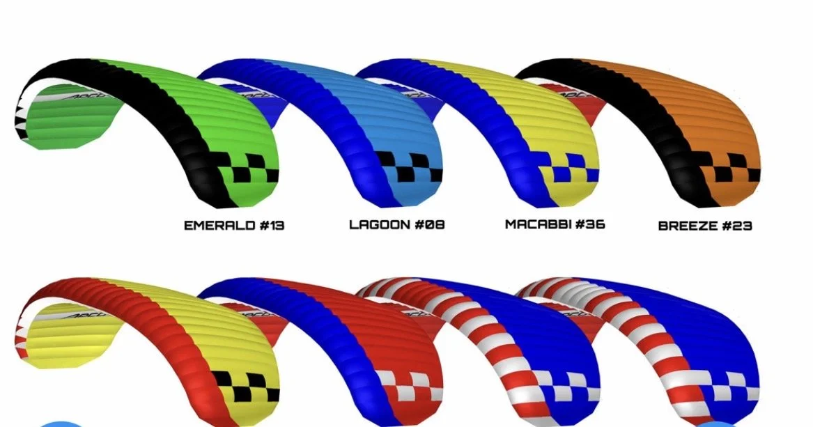 Colorful paragliding wings in various colors with black checkered patterns, labeled with names and numbers like Emerald #13, Lagoon #08, Macabbi #36, Breeze #23, and others.