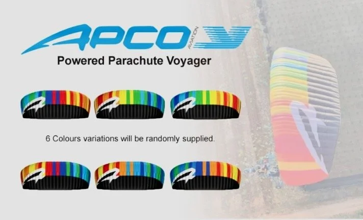 Advertisement for APCO AV Power Parachute Voyager, showing six different color variations of parachute harnesses with rainbow patterns and a background image of a colorful powered parachute in flight.